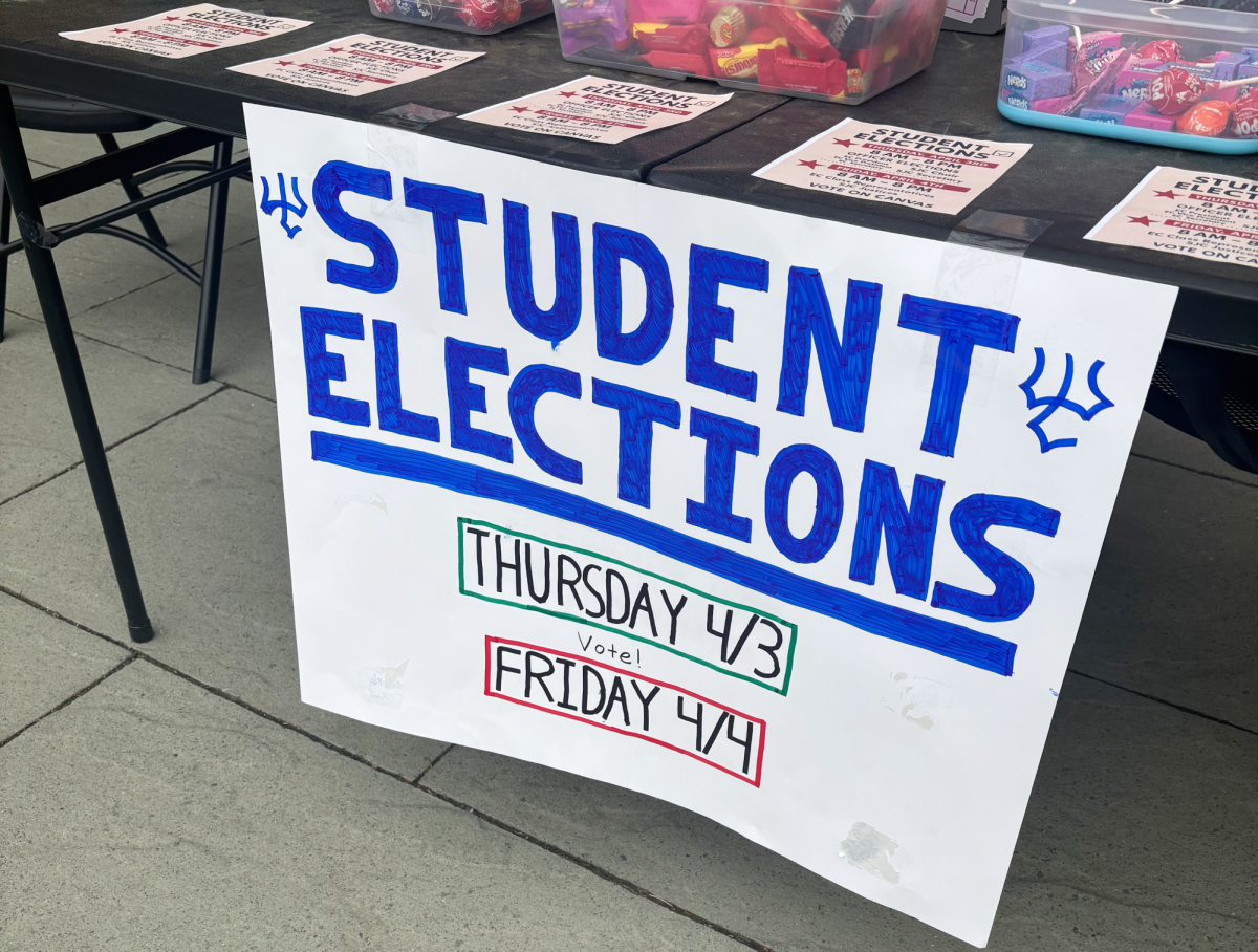 Students tabling outside Commons encourage other students to vote in this year’s student election. 